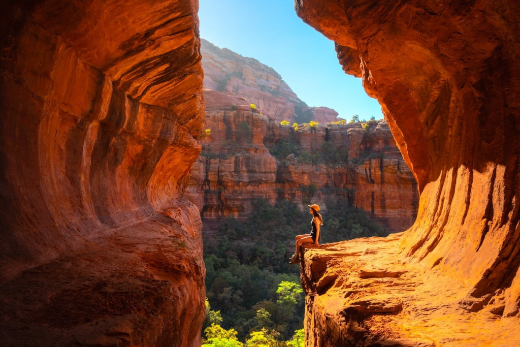 Hiker on Devils Bridge natural arch Sedona Arizona red rocks
